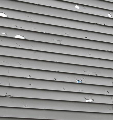 Siding repair for damaged or warped panels