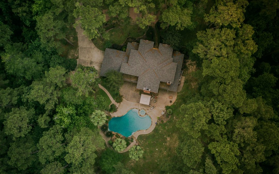 aerial shot house roof in woods